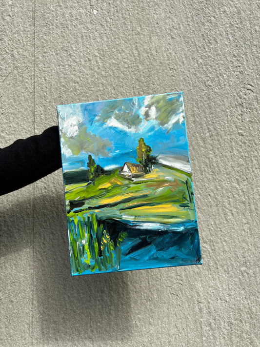 Hand-painted landscape artwork with a bright blue sky and a small cottage, vibrant and colorful, perfect for home decor