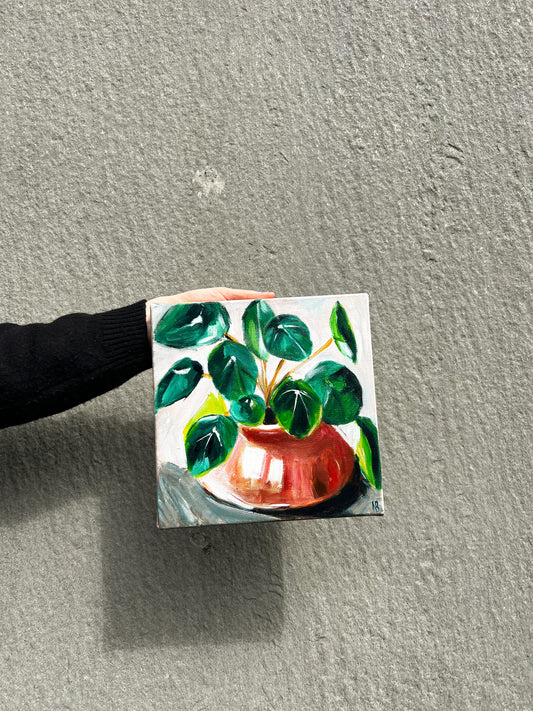 Painting of a green leafy plant in a red ceramic pot, set against a light background, capturing a serene and natural aesthetic